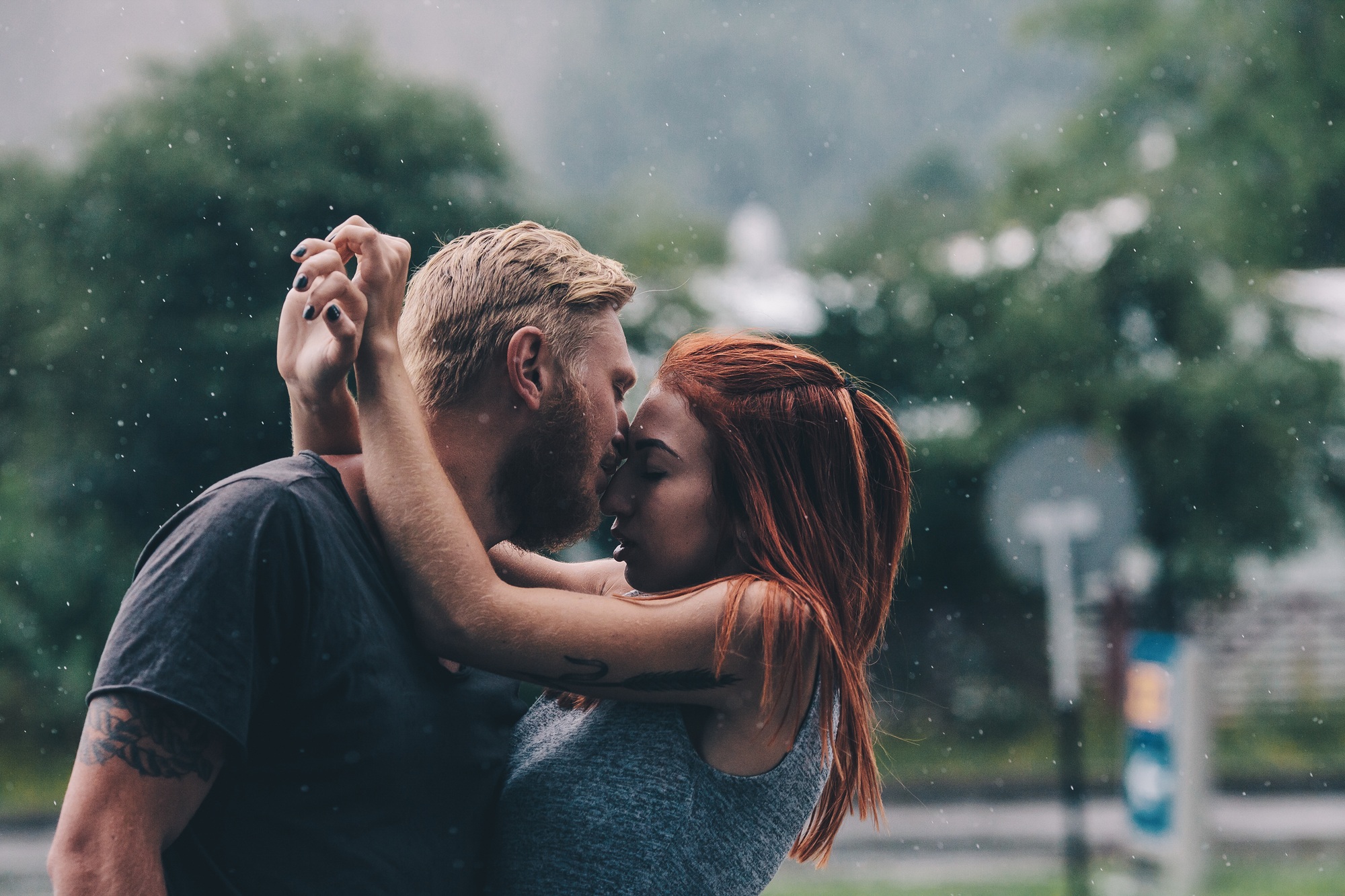 beautiful couple kissing in the rain
